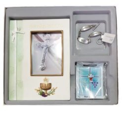 First Holy Communion gift set in a tray: a book with a crucifix cover, a silver charm bracelet, and a small blue card package.