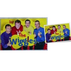 Group photo of The Wiggles: four members in bright colored shirts (purple, red, yellow, blue) giving thumbs up in front of a yellow background with 'The Wiggles' logo visible.