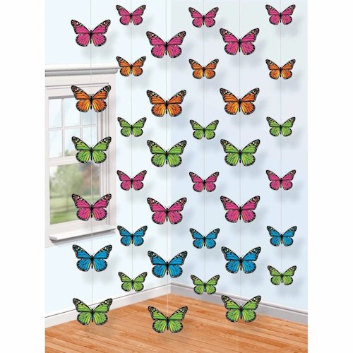 Colorful butterfly ornaments hanging in a sunlit corner of a room as decor.