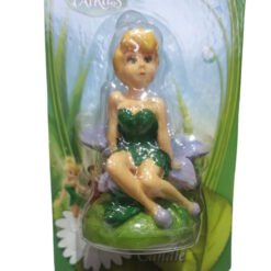 Small plastic fairy figure with blonde hair in a green dress seated on a purple-lilac chair inside clear plastic packaging