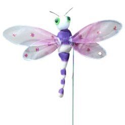 Plush purple and white dragonfly toy with pink-tinted wings mounted on a green stake on display