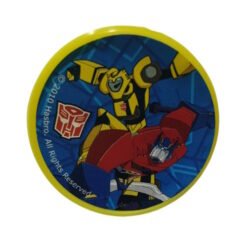 Round badge featuring Transformers' Bumblebee in yellow and black with a red car, Autobot logo, and Hasbro copyright text.