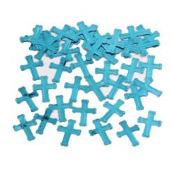 Assorted blue plastic crosses scattered on a white surface, random arrangement underscoring a decorative motif