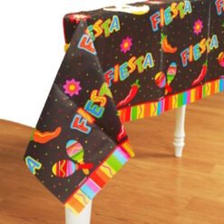 Table covered with a black Fiesta-themed cloth featuring colorful 'FIESTA' text, peppers, maracas, flowers, and a bright striped border.