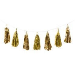 Gold tassel garland hanging from a thin string against a white background, decorative party décor.