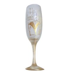 Champagne flute with frosted glass, gold heart and 'Happy Anniversary' inscription on the bowl abbreviation, celebrating an anniversary.