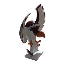 Plastic eagle figurine with wings spread, perched on a white base.