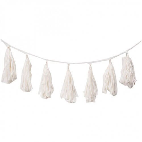 White tassel garland hanging on a string, decorative bunting for celebrations