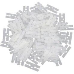 Pile of small white plastic cable tie segments scattered together, ready for use or disposal