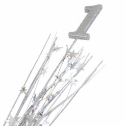 Silver glitter cake topper in the shape of the number 1 with a sparkly starry tinsel decoration.