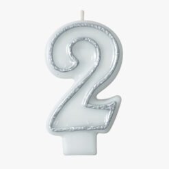 White number 2 birthday candle with silver glitter trim on a white background.