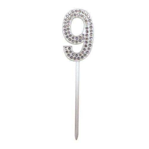 Silver number 9 cake topper encrusted with rhinestones on a stick