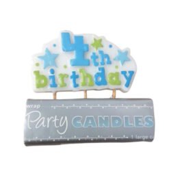 1st birthday candle on a white cloud-shaped base with blue and green letters, resting on a gray package labeled 'Party Candles'
